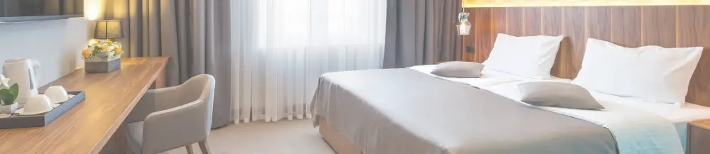a hotel room with a bed and a desk