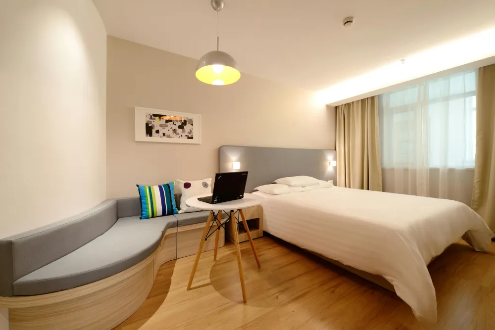 a bed sitting in a bedroom next to a window