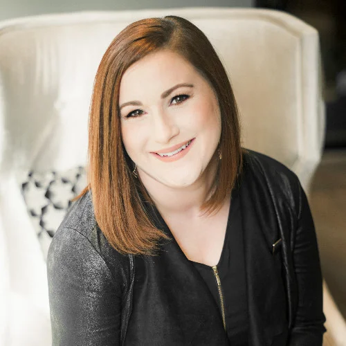 a woman sitting in a chair with a smile on her face