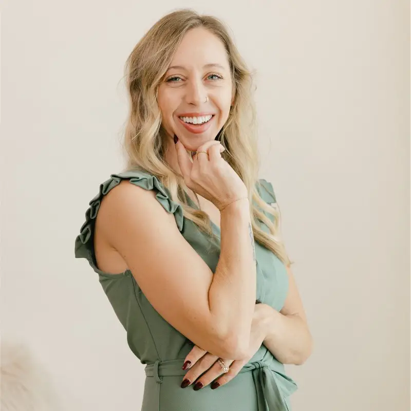 a woman in a green dress posing for a picture