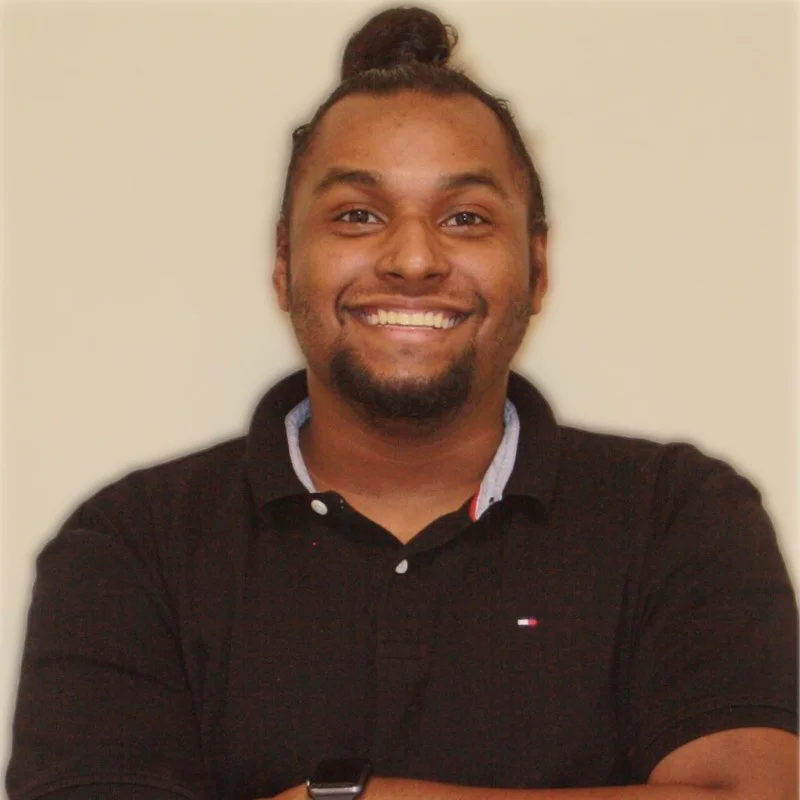 a man with his arms crossed smiling