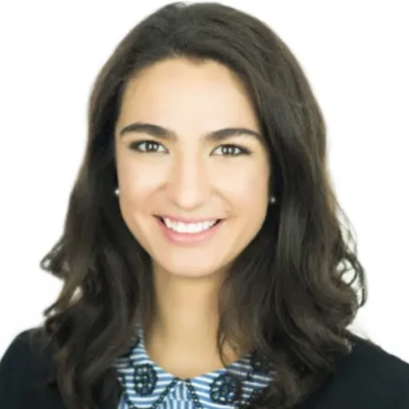 a woman with long dark hair wearing a black jacket